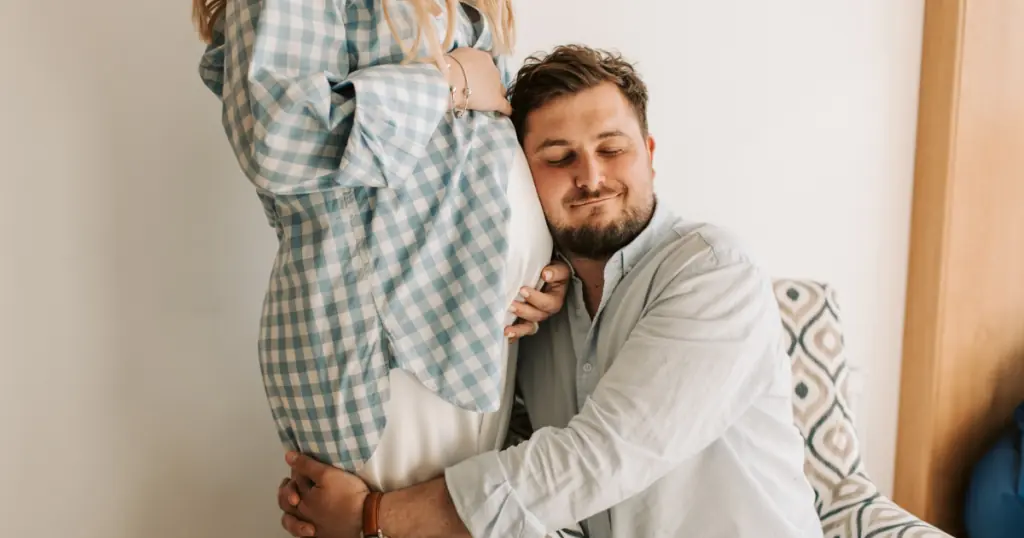 Pregnancy After 35, Advanced Maternal Age, man hugging pregnant woman