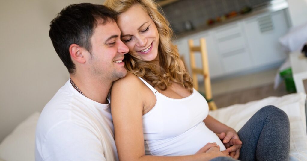 Pregnant Mom and husband snuggling, how sex and help induce labor