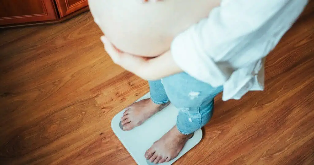 pregnant mom standing on a scale, pregnancy weight gain